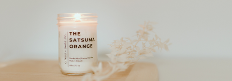 satsuma orange candle on a table top