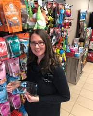 Photo of Jenn standing in store at Pet Grocer holding PIJAC Eastern Canada 2022 Award