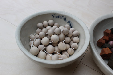 natural wooden beads in a bowl
