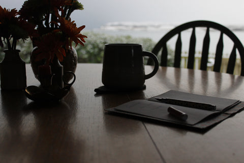 notebook and cup of tea on table