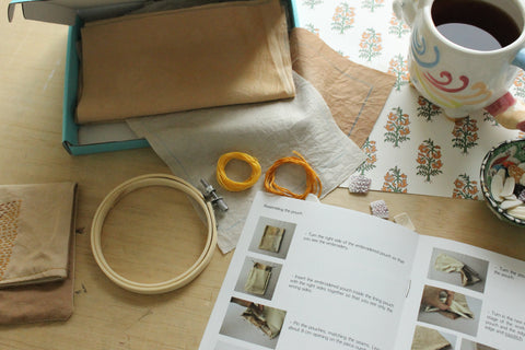 embroidery loop, instructions booklet, threads, cup of tea