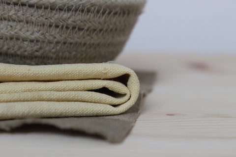 little basket and piece of fabrics dyes with buddleia flowers