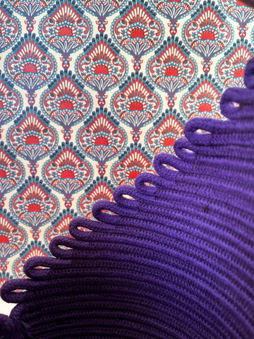 purple cord and batik wallpaper in the background