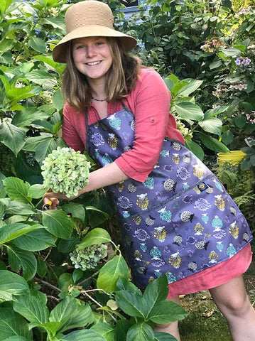 Girl gardening with her Splash Fabric apron