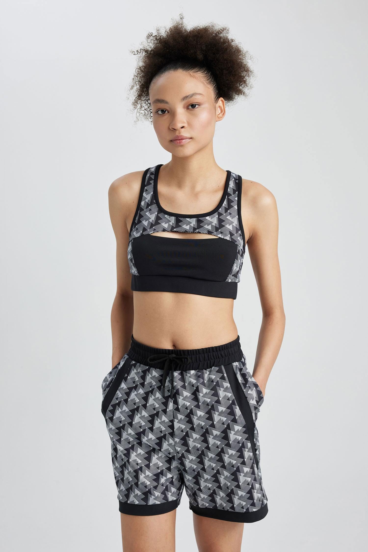 ASOS 4505 medium support sports bra with racer back in black matte and  shine