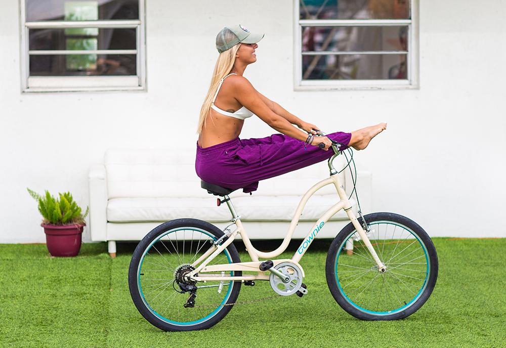 Woman wearing savannah pants balancing on bike