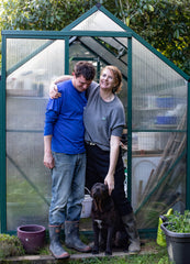 Owners outside greenhouse