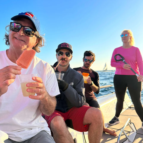 Friends Enjoying Hail M Cocktails on a boat