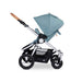 Bumbleride Era Stroller profile in a light turqouise colour called Seaglass showing large rear air-filled tires roomy storage basket and cork handlebar