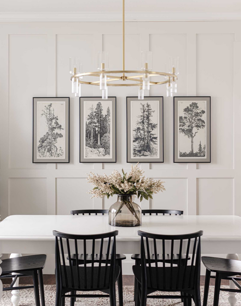 Four pieces of tree, nature inspired artwork pieces hanging in a dining room.