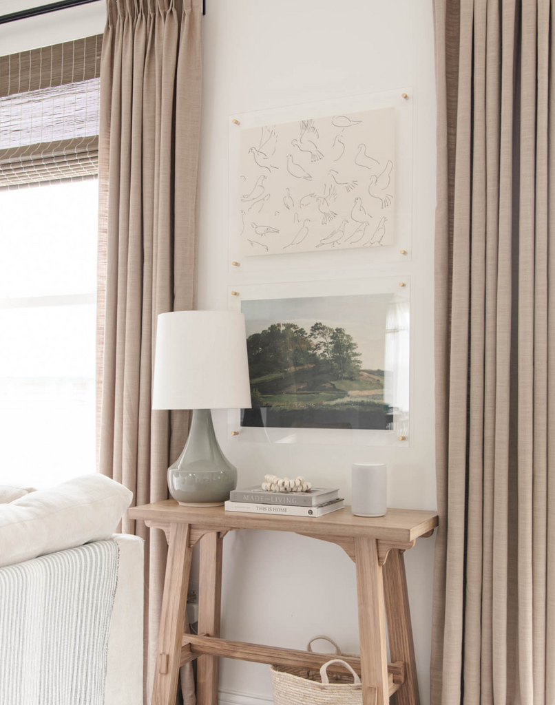 Neutral, nature inspired artwork pieces hanging in the living room.