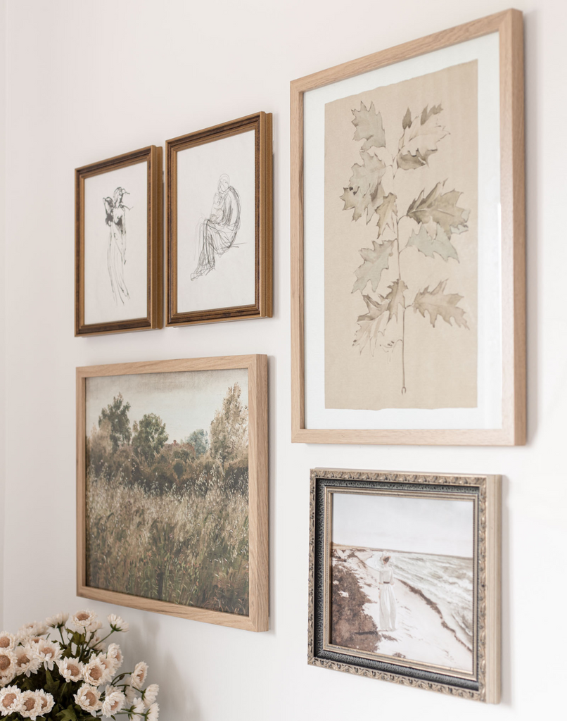 Gallery wall of five nature inspired art pieces that complement each other through similar color and composition.