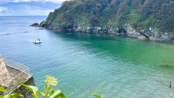 View over the turquoise water on a summers day at Readymoney Cove, Fowey, Cornwall