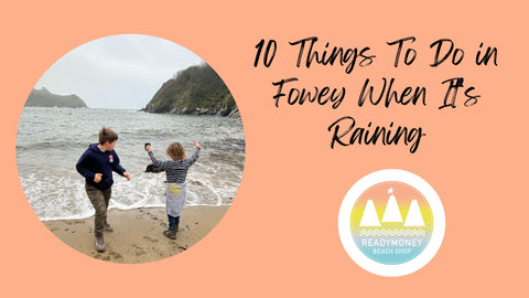 two boys playing in the sand at Readymoney Cove Fowey on a rainy day