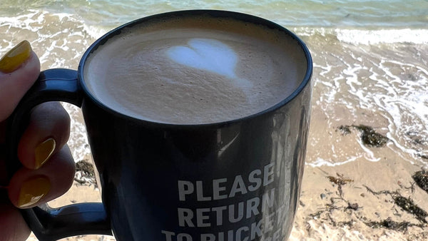 a readymoney beach shop reusable cup against the background of the sea