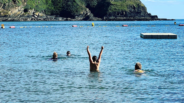 Swimmers at Readymoney Cove beach Fowey Cornwall