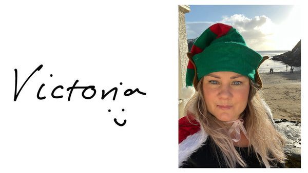 Victoria wearing an elf hat at Readymoney Cove, Fowey
