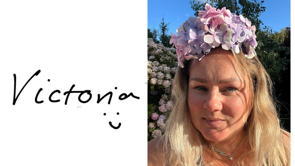 Victoria, owner of Readymoney Beach Shop, wearing a hydrangea flower crown for Fowey Regatta Week