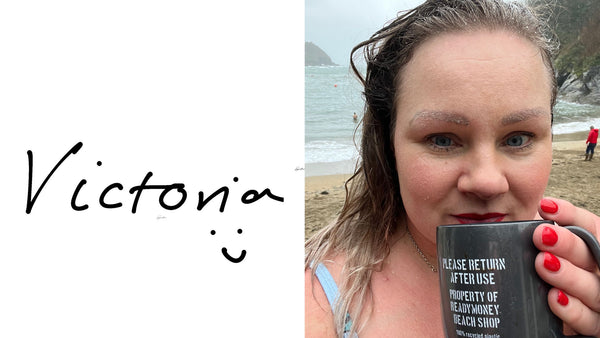Victoria, owner of Readymoney Beach Shop drinking a hot chocolate after a swim