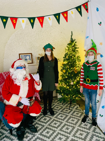 Santa by the Sea at Readymoney Cove, Fowey, Cornwall with his two elves, Isla and Barnaby