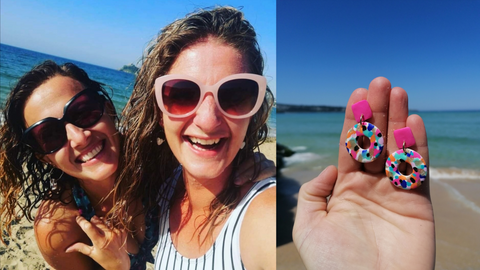 Best Makes Cornwall. Tara and Becky smiling at the camera on the beach plus a pair of their colourful handmade earrings.