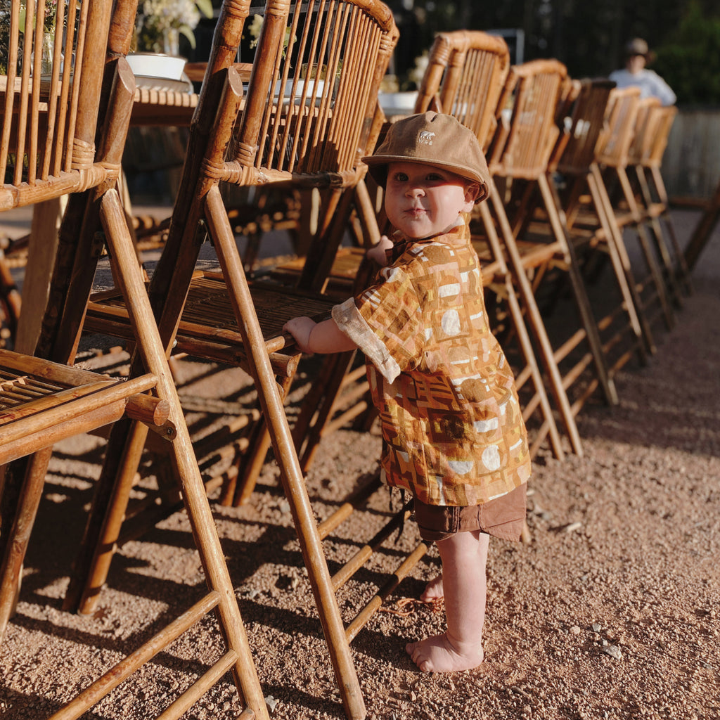 Boy wearing kids hat at camp