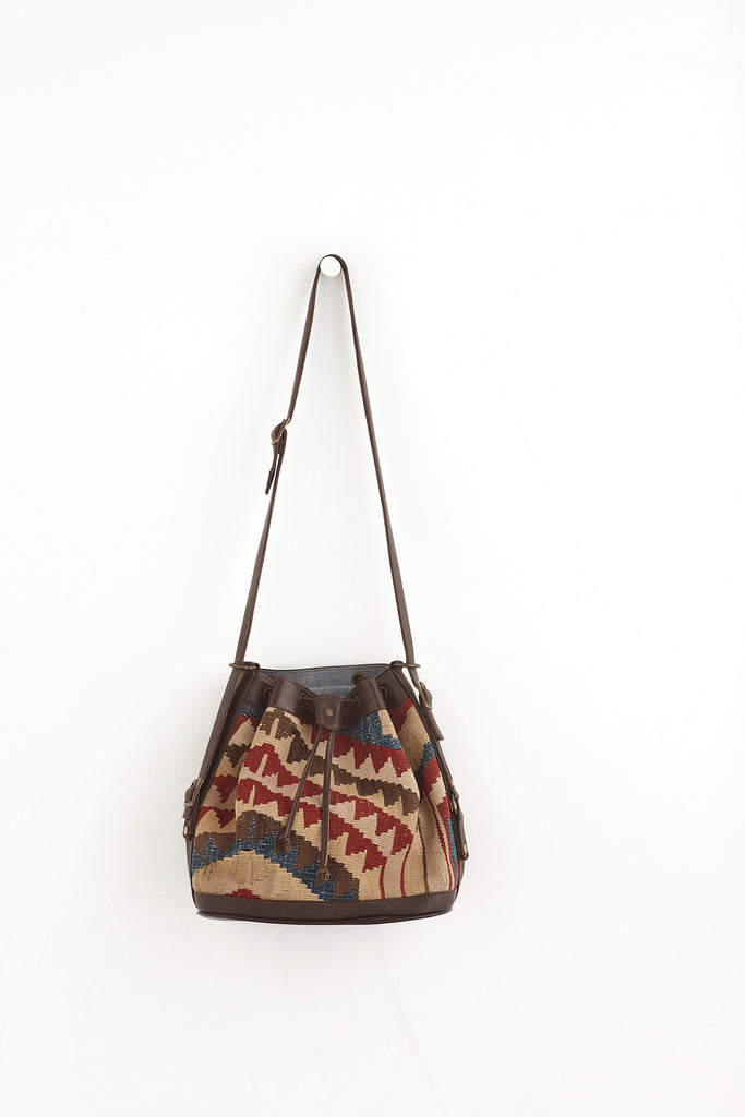 Multi coloured medium kilim and leather drawstring handbag front