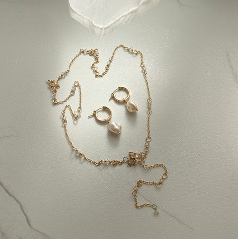 Zurina Ketola's Long Herkimer Diamond Necklace paired with the Organic Huggie Pearl Hoop Earrings. 