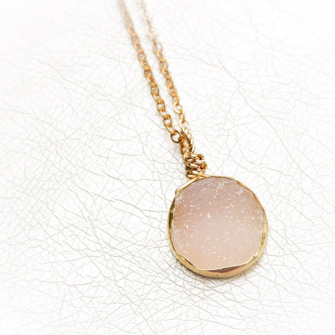 Close up of bespoke Zurina Ketola pink druzy necklace with 14K gold fill chain and vermeil details. 