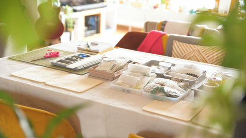 Peeking over the corner at the workspace for a upcycled bracelet workshop. 