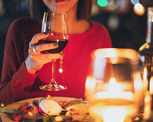 women having a glass of wine with dinner