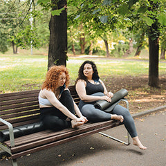 two women taking a break from their exercise routine on a hot day