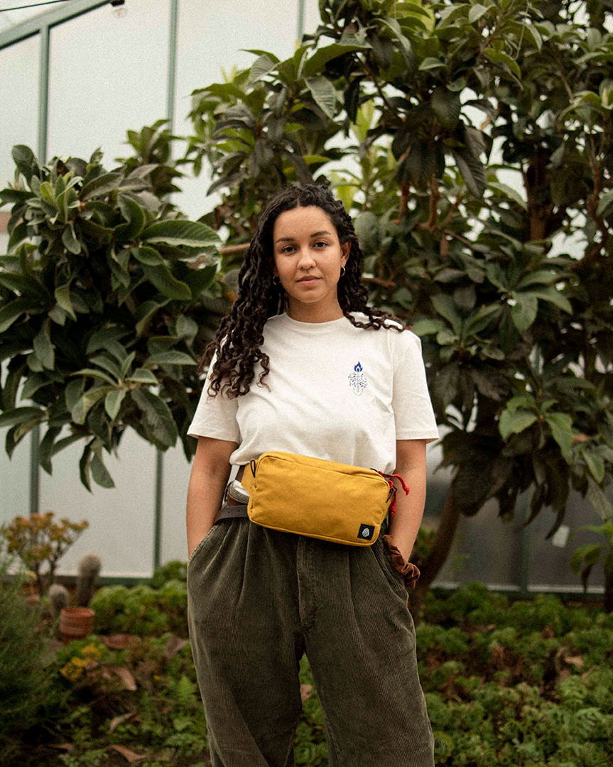 Scout pack bumbag worn by eliza in greenhouse