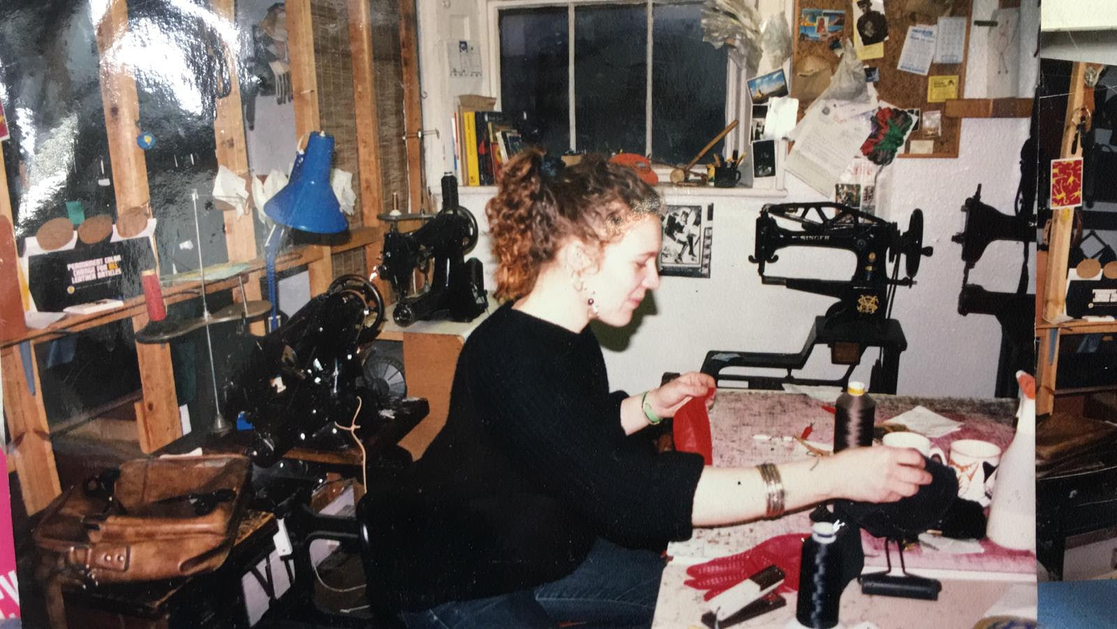 The Level Collective British Made Backpacks Master Maker Lesley at her desk stitching backpack together.