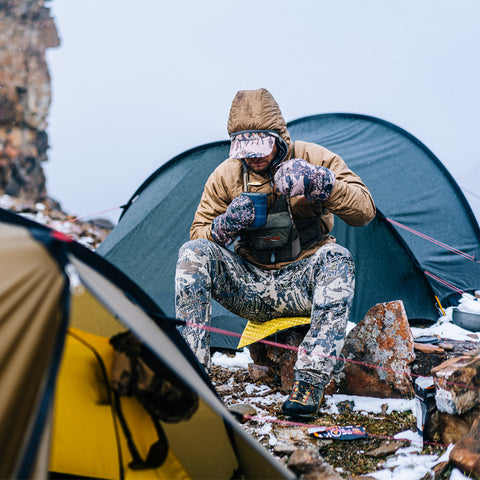 Kelvin Aerolite Jacket in Optifade Open Country - Man in Sitka gear sitting at a campsite