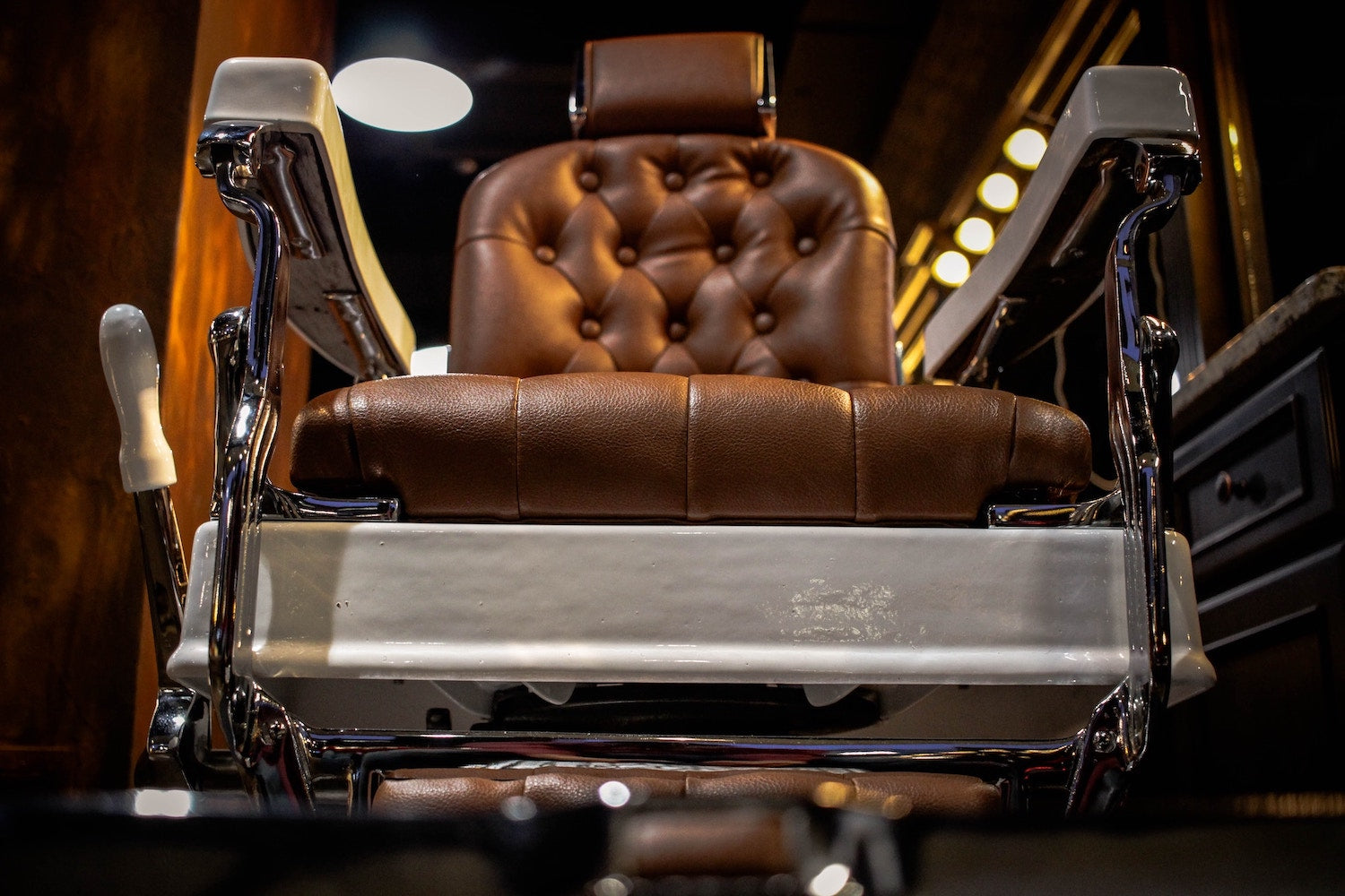 A brown leather barbershop chair