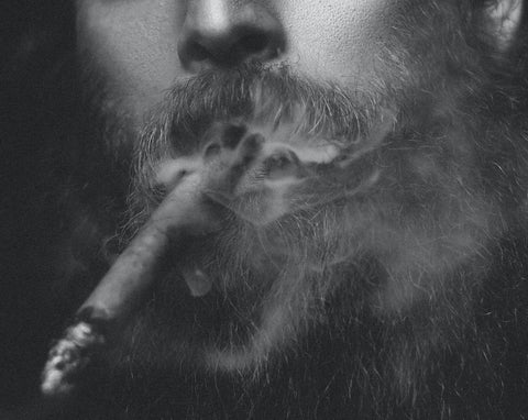 Man with beard smoking cigar