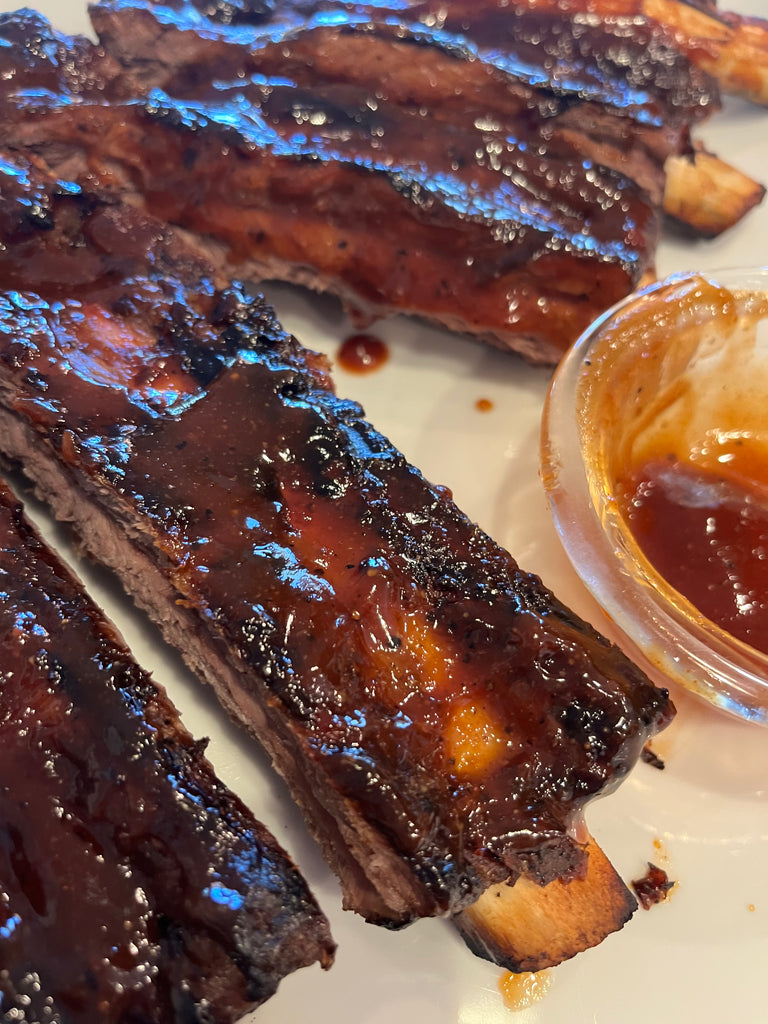 Grilled bison ribs with extra barbecue sauce