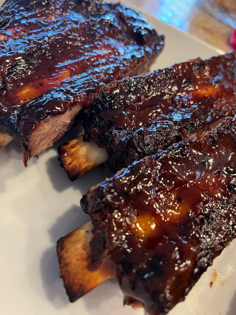 Ribs on a platter, glazed with barbecue sauce