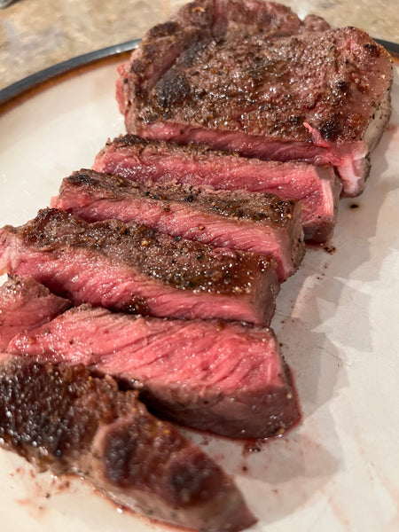 Bison ribeye steak sliced on a plate