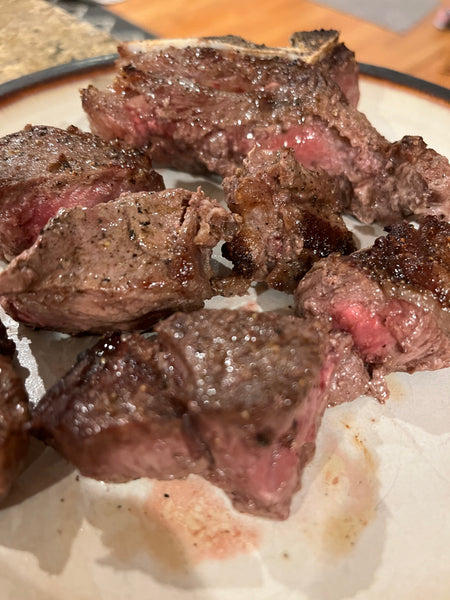 Cooked elk porterhouse steak