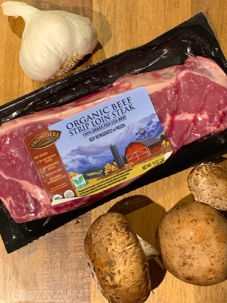 Frontiere Natural Meats strip steak with mushrooms and garlic