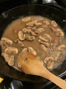 Mushroom sauce reducing in pan