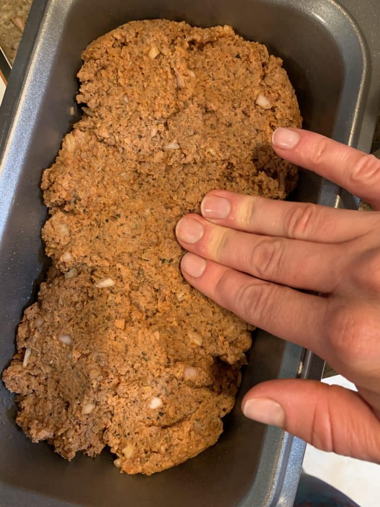 Pressing meatloaf into a pan