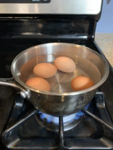 Eggs boiling in a pot