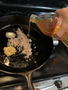 Pouring ingredients into a cast iron skillet
