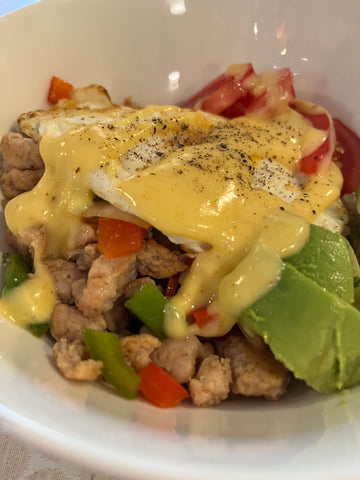 Ground chicken breakfast bowl topped with homemade Hollandaise sauce