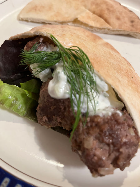Meatballs in a pita with sauce and dill