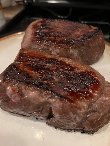Elk ranch steaks seared and resting on a plate