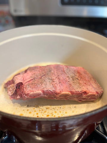 Bison short ribs browning in a Dutch oven